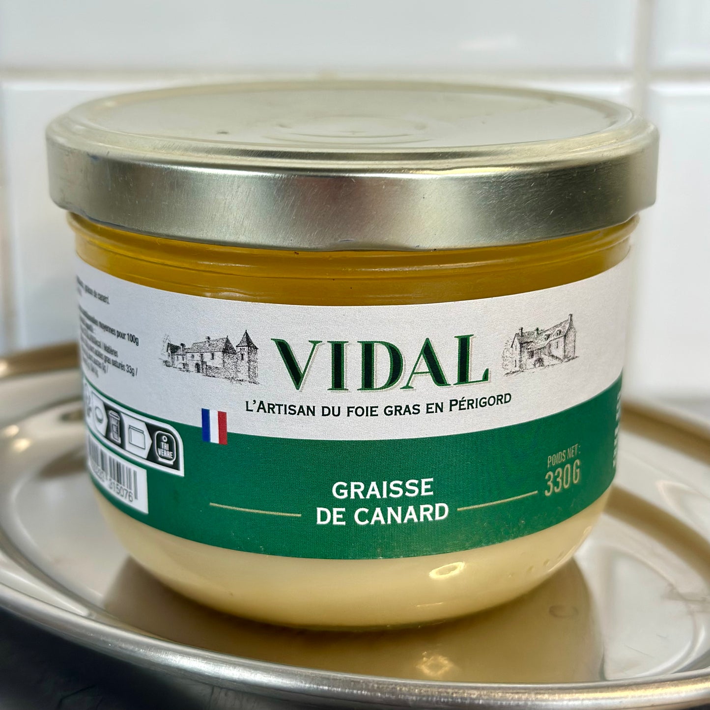 Jar of Vidal goose fat on a reflective surface with a white background