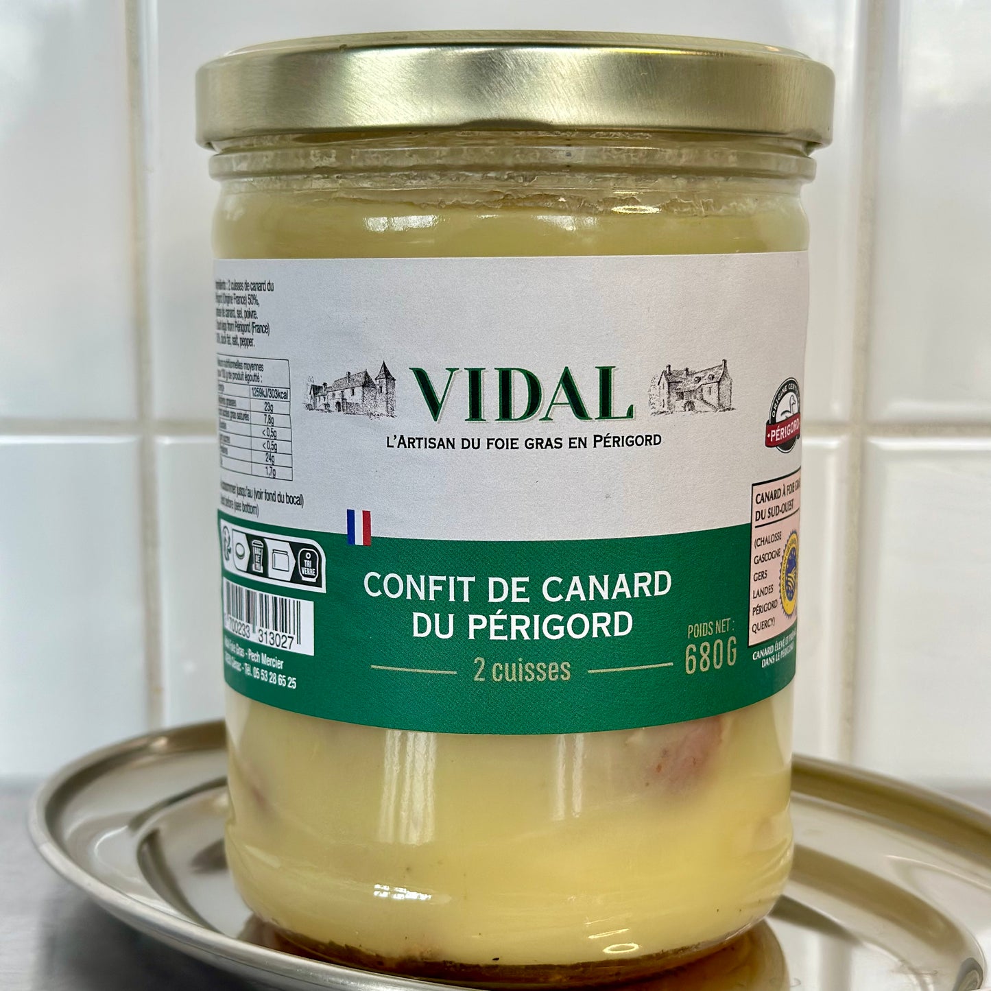 Jar of Vidal confit de canard du Périgord on a white surface with a tiled wall background